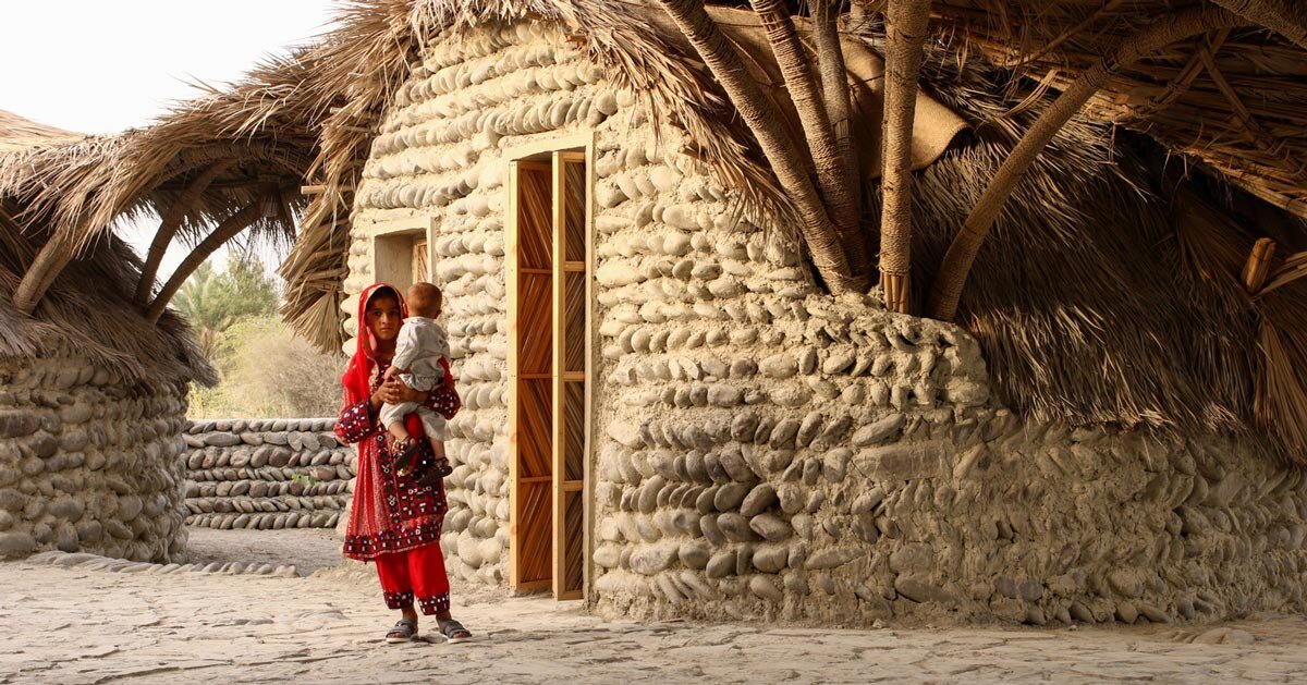 vaulted palm canopy shields dry stone guesthouse cluster in iran