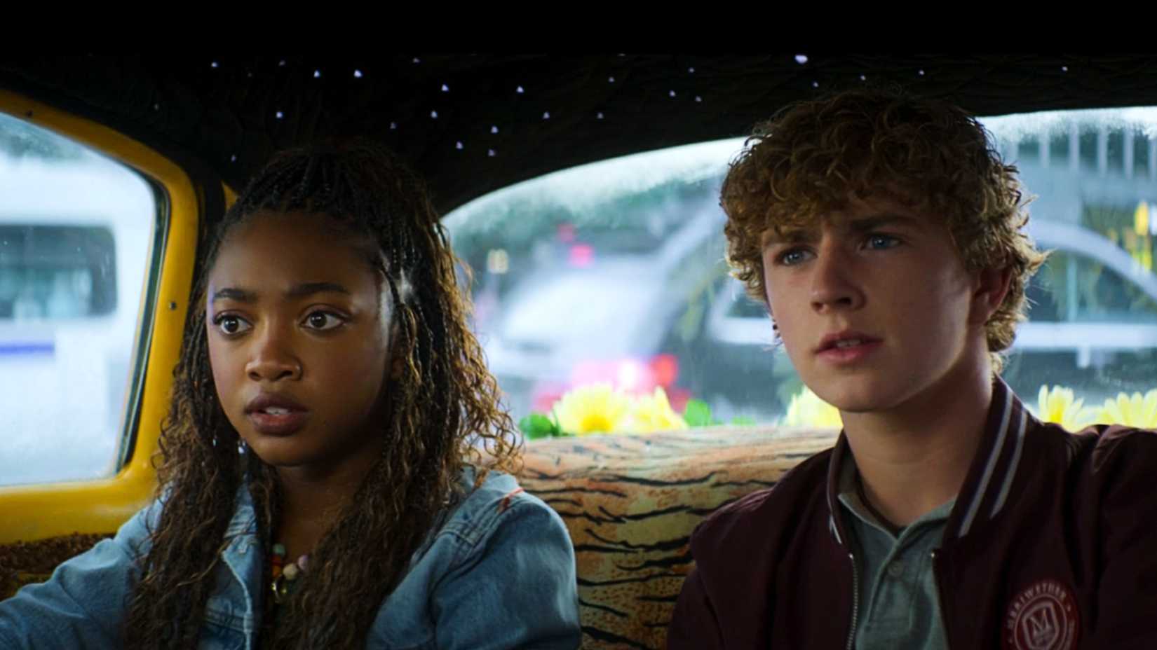 Percy and Annabeth sitting in a cab in Percy Jackson and the Olympians season 2 episode 1