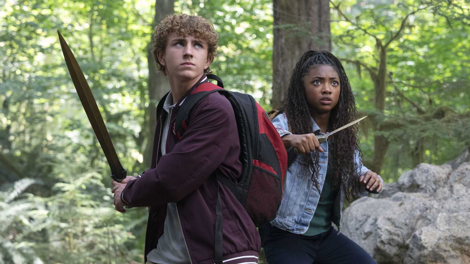 Percy and Annabeth stand in defensive positions with weapons in Percy Jackson and the Olympians season 