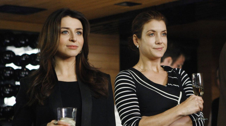 Amelia Shepherd holding glass next to Addison Montgomery holding champagne flute