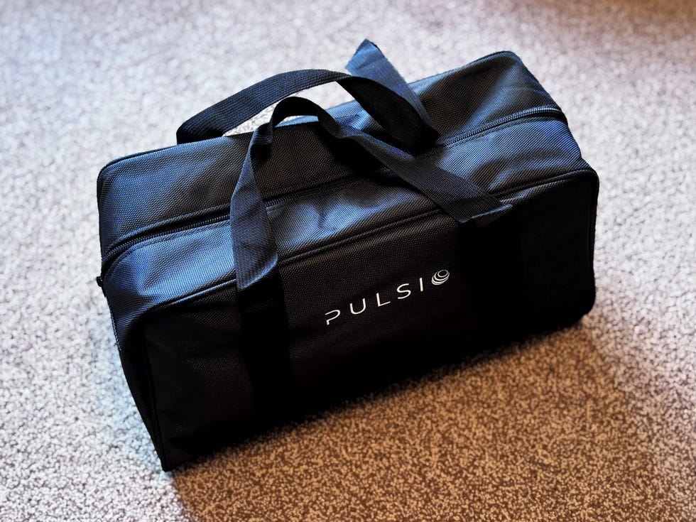 black rectangular bag with two handles and a logo