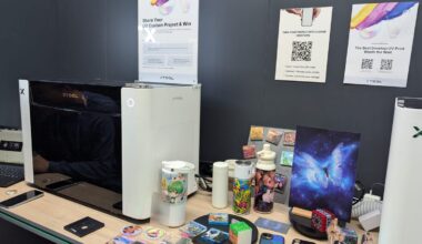 A white and black printer with printed materials all around it