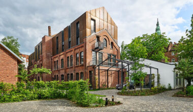 corten steel extends former laundry complex’s brick buildings in kassel