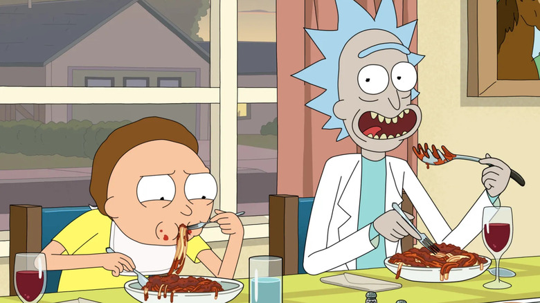 Rick and Morty enjoy a spaghetti dinner.