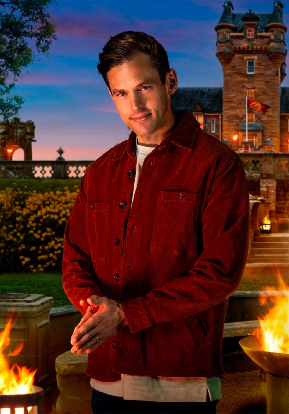 a person standing with clasped hands in front of a scenic backdrop