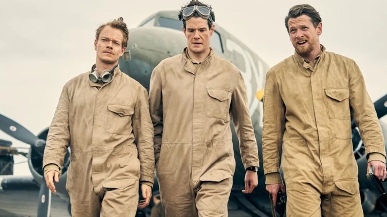Jock Lewes (Alfie Allen), David Stirling (Connor Swindells) and Paddy Mayne (Jack O'Connell) walking away from a plane in SAS: Rogue Heroes