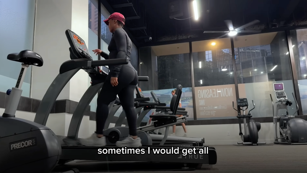 woman exercising on an elliptical machine in a gym