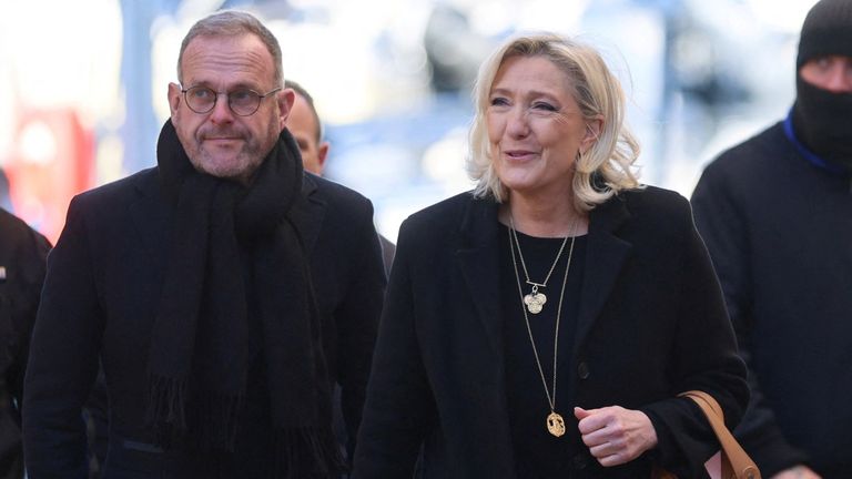 Marine Le Pen, right, arrives at the service. Pic: Reuters