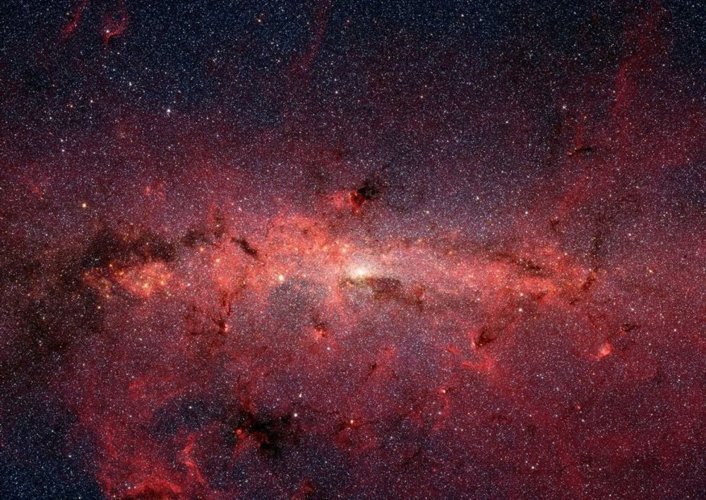This is an infrared image of the Milky Way's galactic bulge from NASA's Spitzer Space Telescope. The region is dense with stars and their planets, but is obscured by thick dust and gas. It can't be viewed in optical light, but infrared telescopes can see some of its detail. The upcoming Nancy Grace Roman Space Telescope, an infrared unit, is designed to survey parts of the bulge in great detail. Image Credit: NASA, JPL-Caltech, Susan Stolovy (SSC/Caltech) et al.