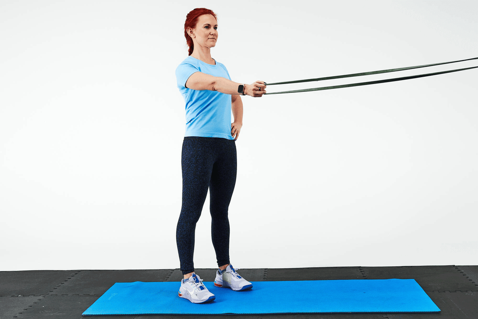 person exercising with resistance bands on a mat
