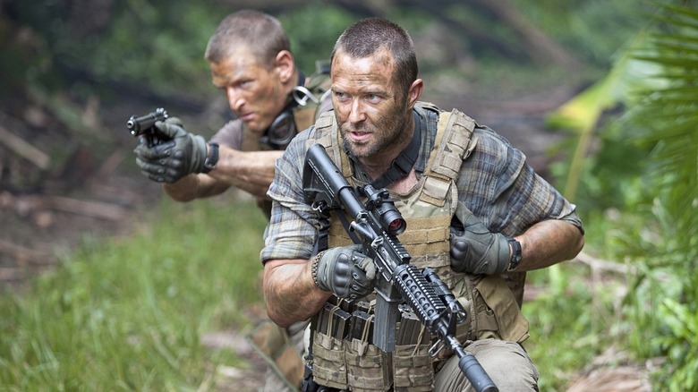 Michael Stonebridge (Philip Winchester) and Damian Scott (Sullivan Stapleton) aim their guns in a jungle in Strike Back