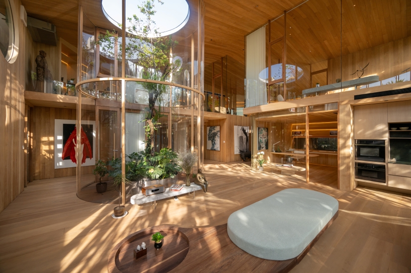 curved glass atriums penetrate residence’s aluminum roof in bangkok