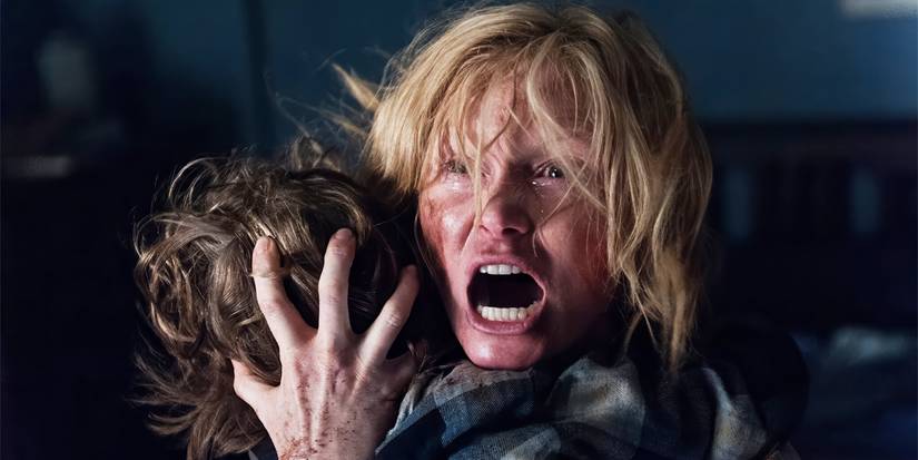 Amelia holding on to Samuel and screaming in fear and anger in The Babadook