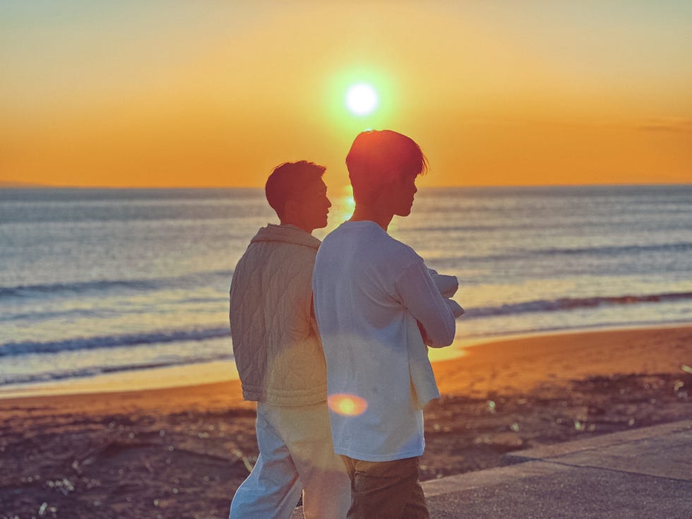 the boyfriend romantic hopefuls talking a sunset walk across the beach.