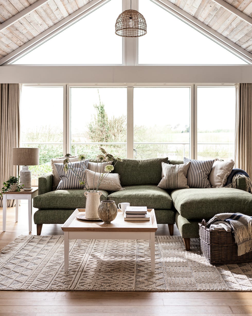 cozy living room featuring a sectional sofa and large windows