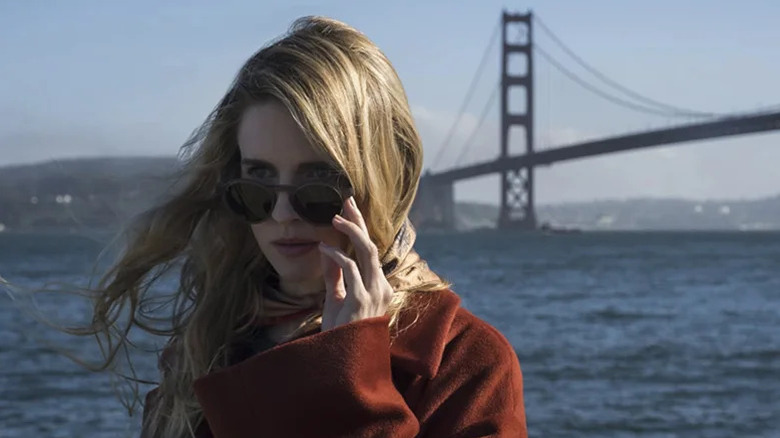 Prairie Johnson (Britt Marling) adjusts her sunglasses by the Golden Gate Bridge in The OA
