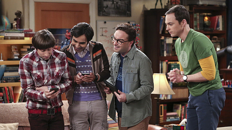 Howard Raj Leonard and Sheldon looking at a phone on The Big Bang Theory