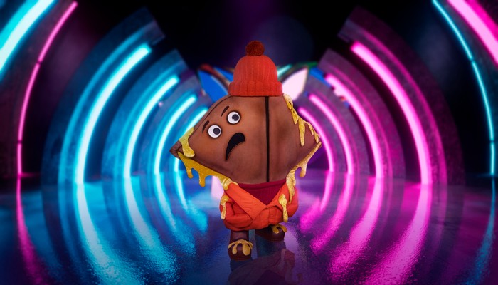 Someone dressed as a cheese toastie with an upset face.