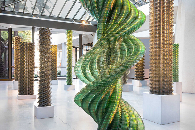 thousands of recycled CDs form reflective vertical sculptures in tara donovan's stratagems