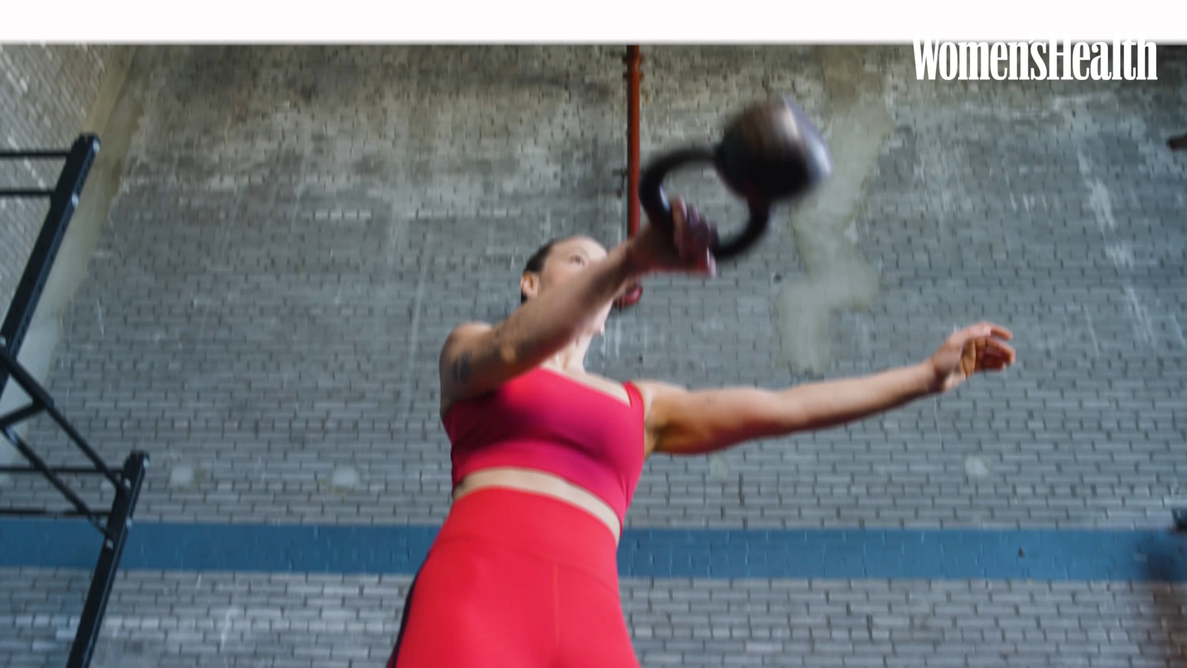 individual performing a squat in a gym setting