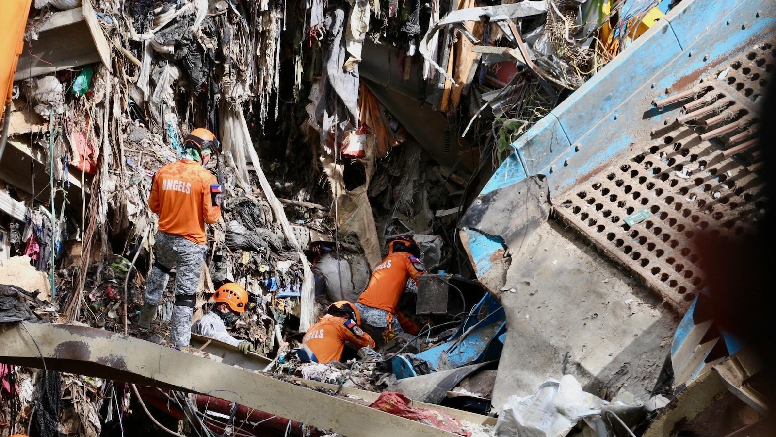Filipino rescuers detect 'signs of life' in deadly garbage avalanche; dozens missing