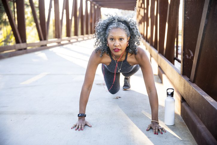 woman doing strength exercises midrun