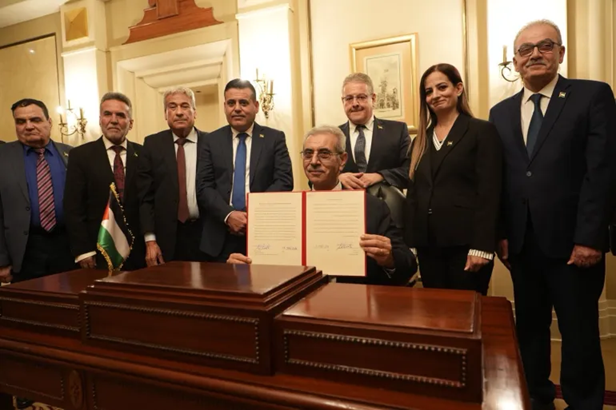 Shaath (seated) with members of the committee after signing the committee's mandate of action (Al Jazeera, January 18, 2026)
