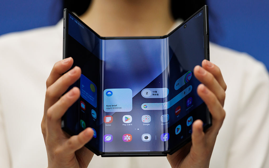 Samsung Galaxy Trifold phone held in woman's hands
