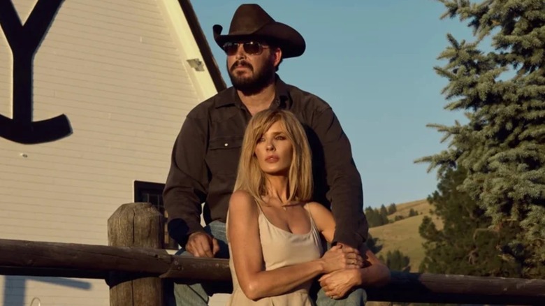 Rip Wheeler (Cole Hauser) and Beth Dutton (Kelly Reilly) lean on a fence holding each other in Yellowstone