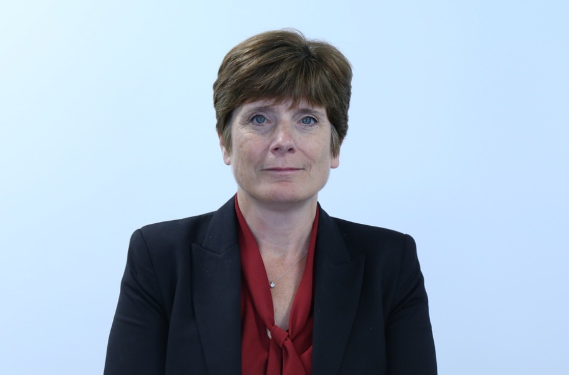 Dr. Alison Cave, MHRA's new Chief Safety Officer, wearing a red top and black blazer.