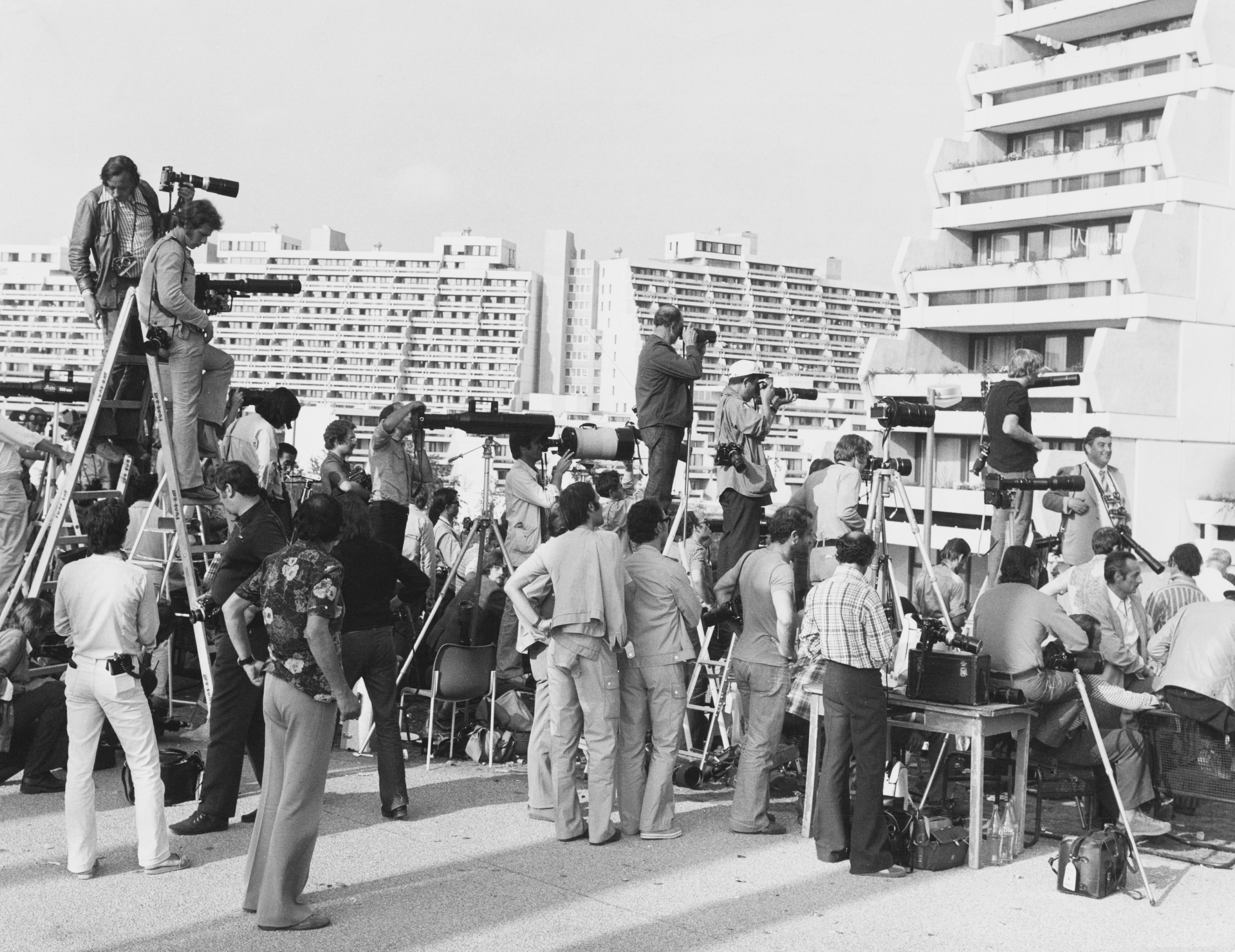 Photographers with cameras and telescopic lenses gathered around the Olympic Village building after the Munich massacre.