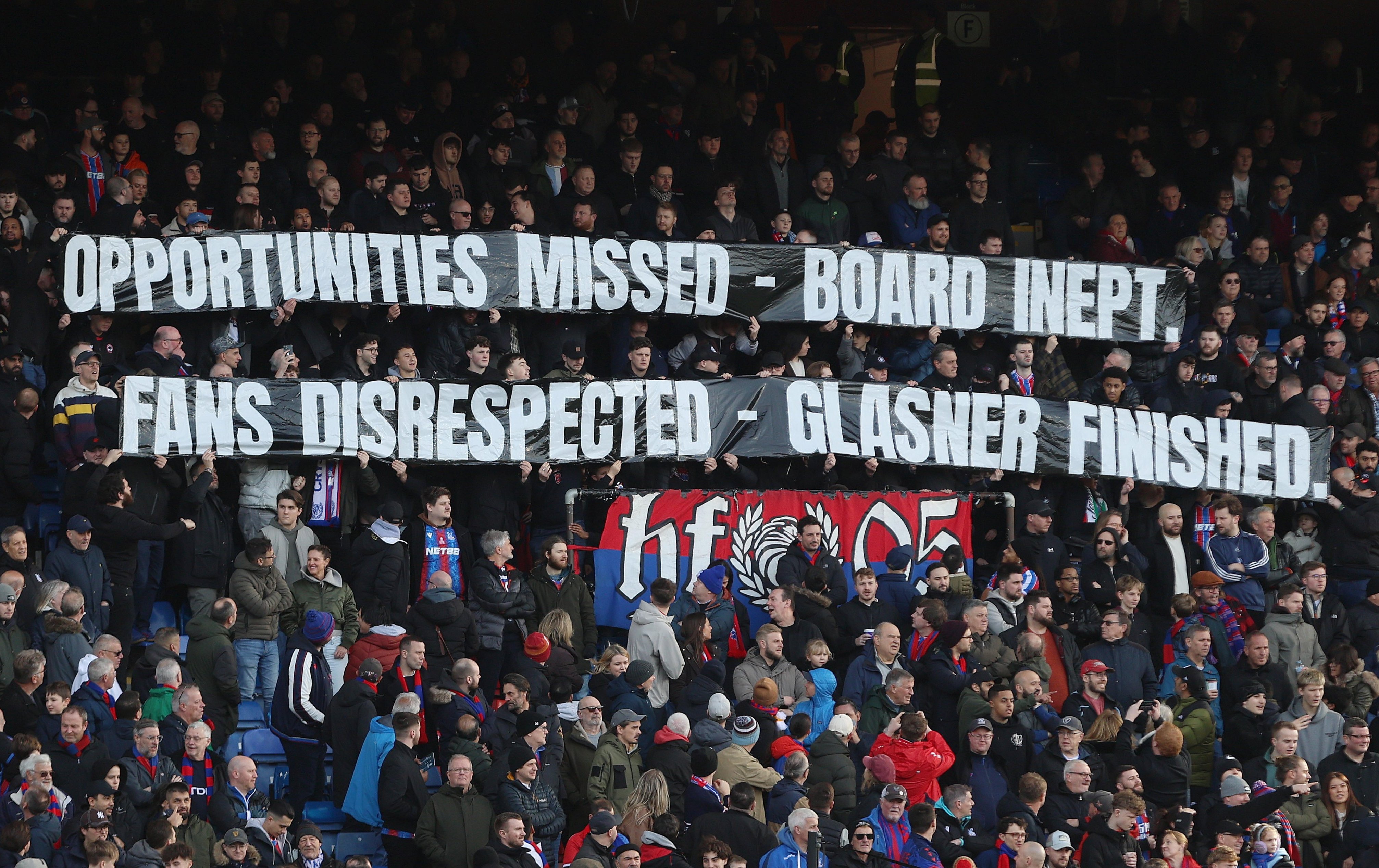 LONDON, ENGLAND, FEBRUARY 21: Crystal Palace fans hold aloft a banner in protest which reads ?Opportunities Missed, Board Inept, Fans Disrespected, Glasner Finished? towards Oliver Glasner Manager of Crystal Palace & Steve Parish, Josh Harris, Woody