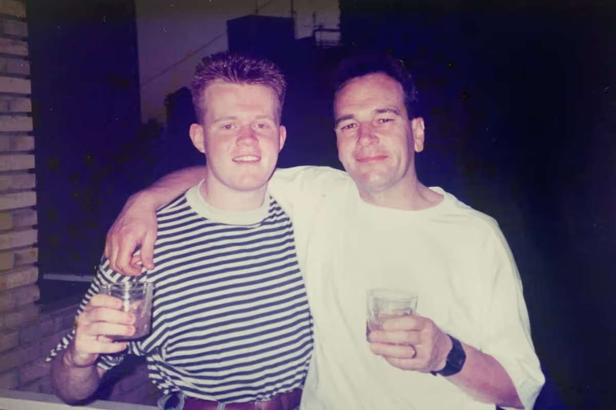 Paul Lindsay and his dad Richard smiling, with their arms around each other.