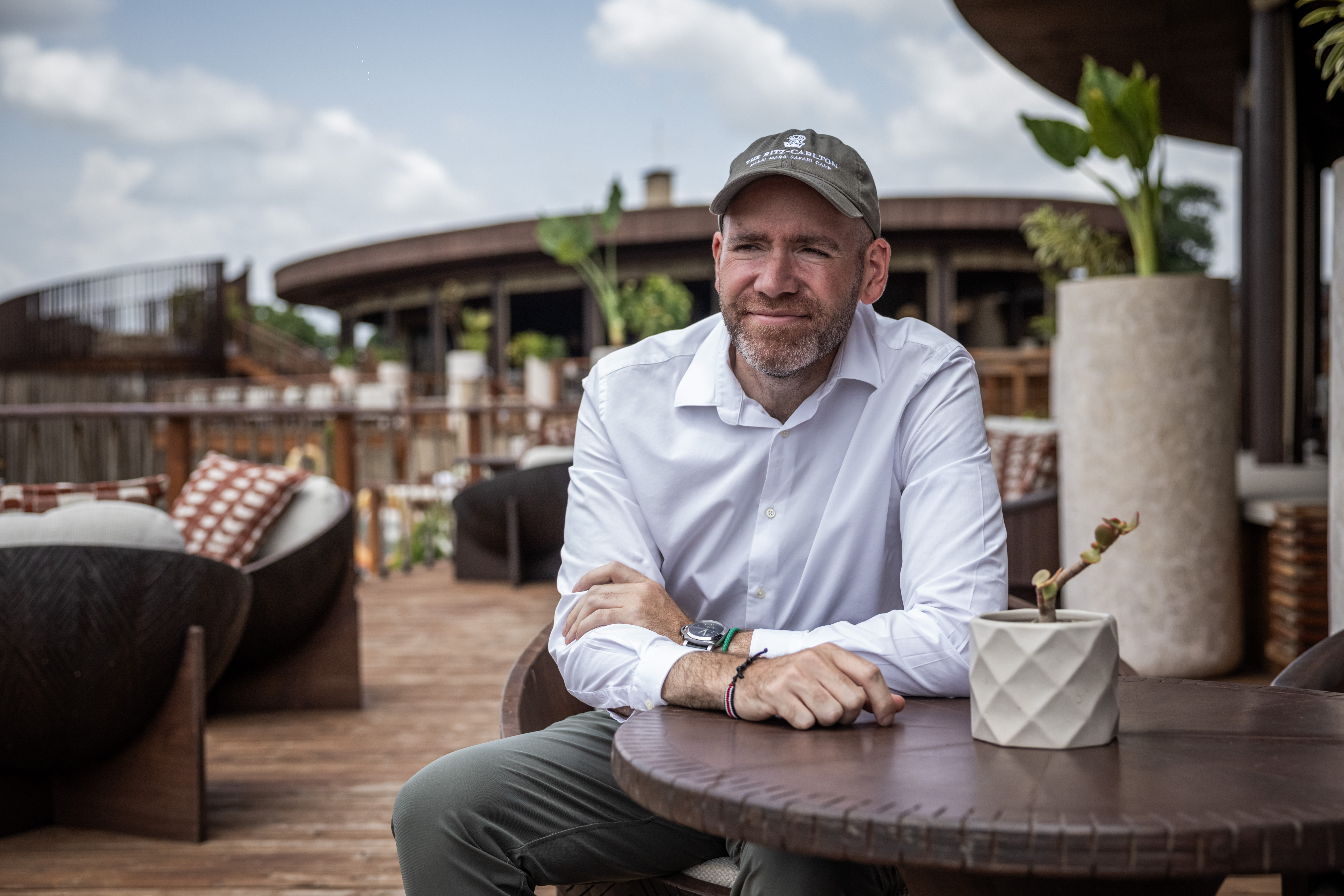 Justin Landry, manager of Ritz-Carlton Safari Camp, sits for a portrait at a table in a restaurant.