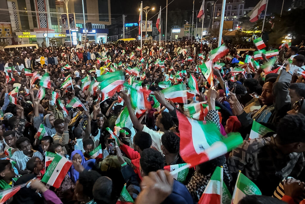 People wave flags to celebrate Israel's official recognition of Somaliland, in Hargeisa on 26 December 2025.