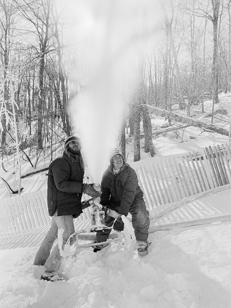 Workers operate a snow-making machine on the Olympic slalom course at Whiteface Mountain ahead of the 1980 Games in Lake Placid, New York.