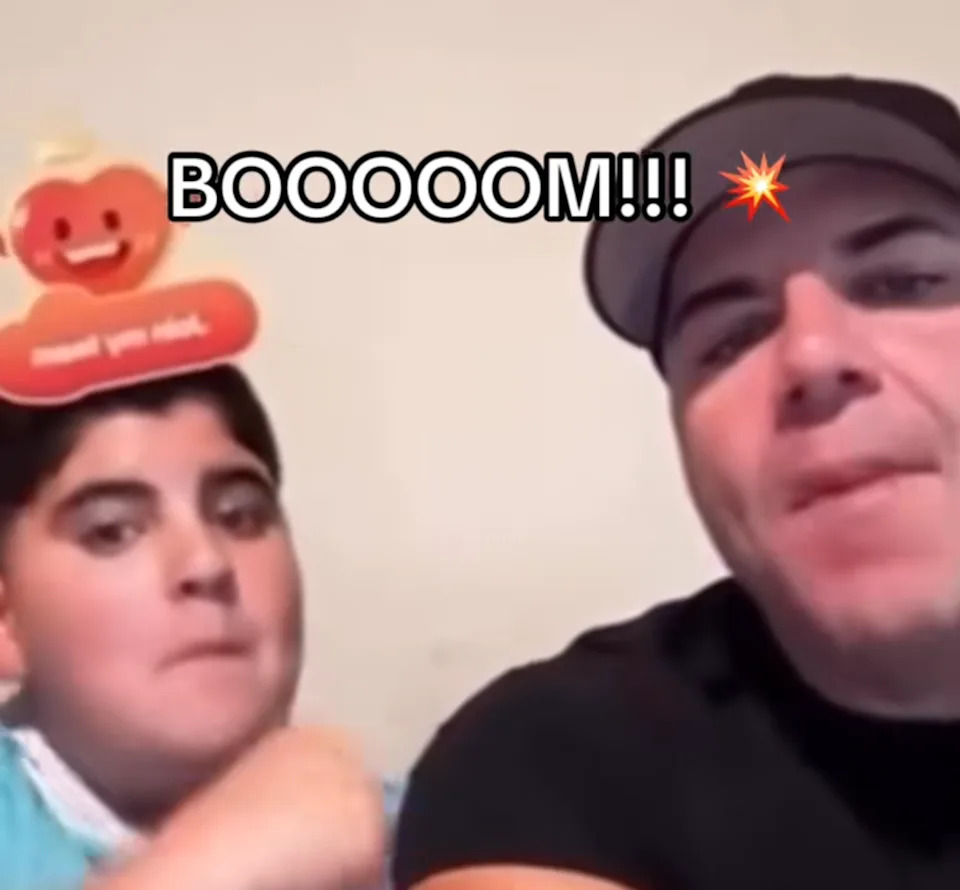 A.J. and Big Justice, a father and his son, in the middle of saying "boom" for the camera.