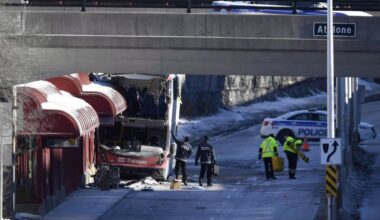 Officials from Transport Canada look at the scene where a double-decker city bus struck a transit shelter at Westboro Station in Ottawa on Saturday, Jan. 12, 2019. THE CANADIAN PRESS/Justin Tang