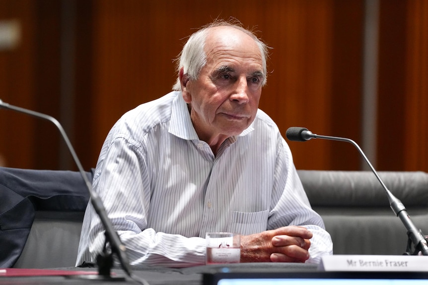 Former RBA governor Bernie Fraser seated in front of a microphone.