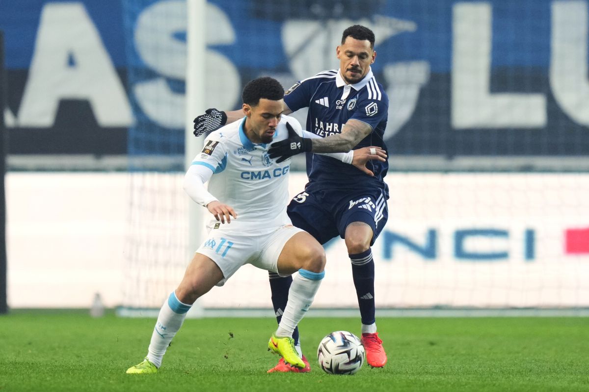 Paris FC's Timothee Kolodziejczak, right, and Marseille's Ethan Nwaneri compete for the ball during the French League One soccer match between Paris FC and Marseille