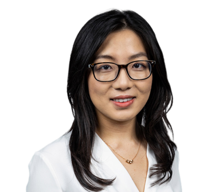 A woman with glasses and a white blouse.