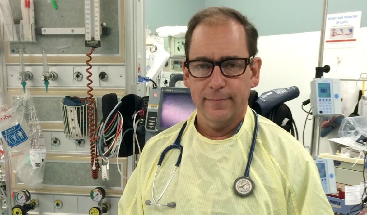 A man stands in a health-care office.