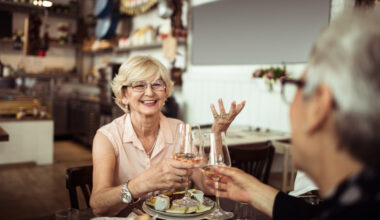 Close up of two senior friends having brunch in a local restaurant.