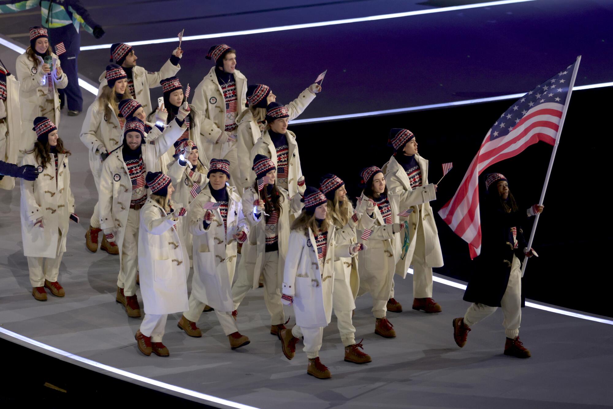 Flagbearer Erin Jackson of Team USA walks with her teammates during the opening ceremony at the 2026 Winter Olympics.