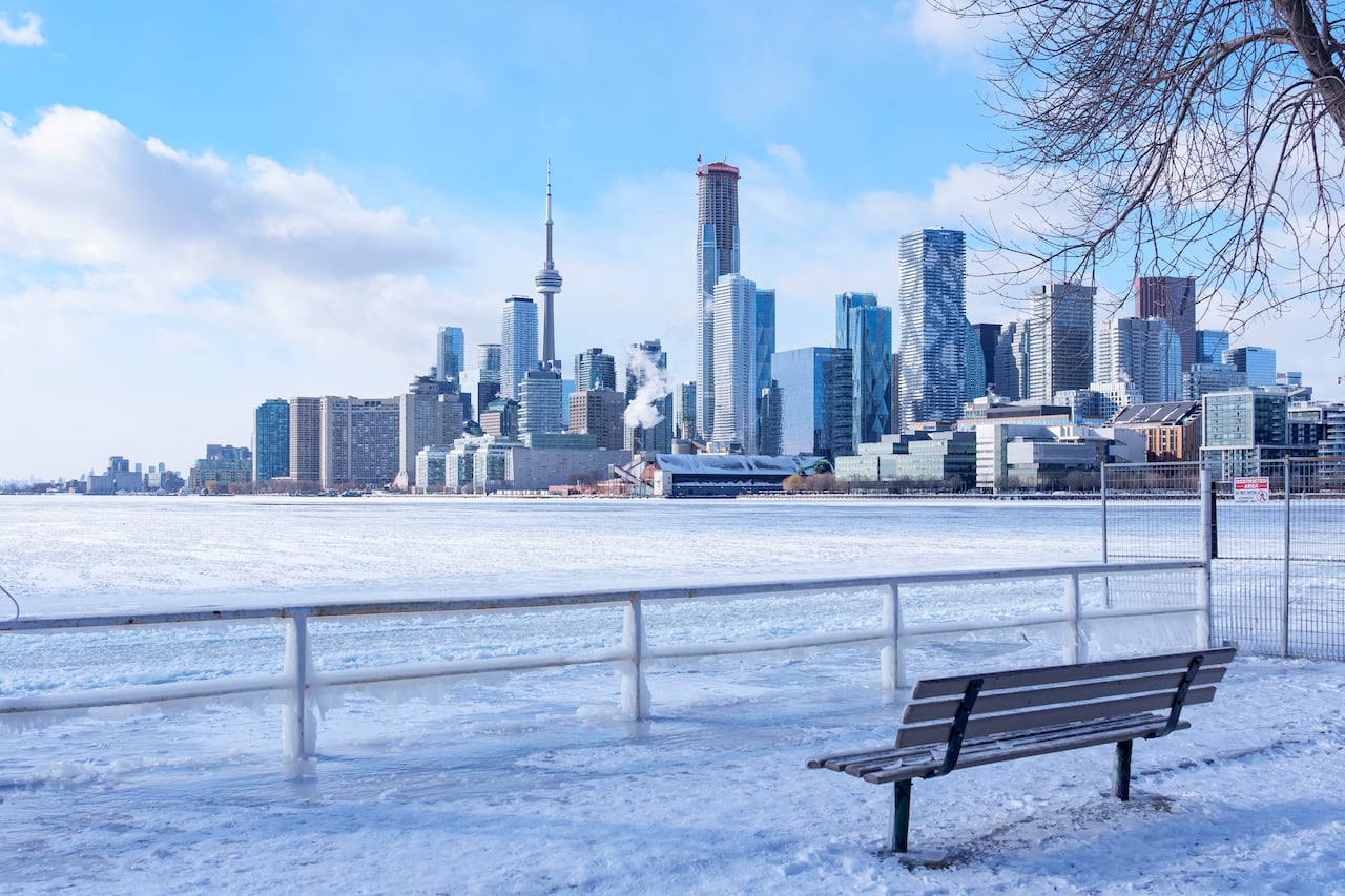 A bench in front of a frozen lake