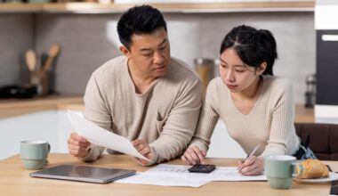 Family counting monthly expenses, kitchen interior stock photo