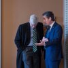 Sen. Bernie Moreno (right), R-Ohio, and Sen. Bill Cassidy, R-La., are shown in a hallway of the Capitol talking. Cassidy is leaning down as Moreno speaks into his ear.