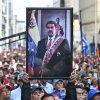 A supporter of ousted Venezuela's President Nicolas Maduro carry his portrait during a rally outside the National Assembly in Caracas on Jan. 5, 2026.