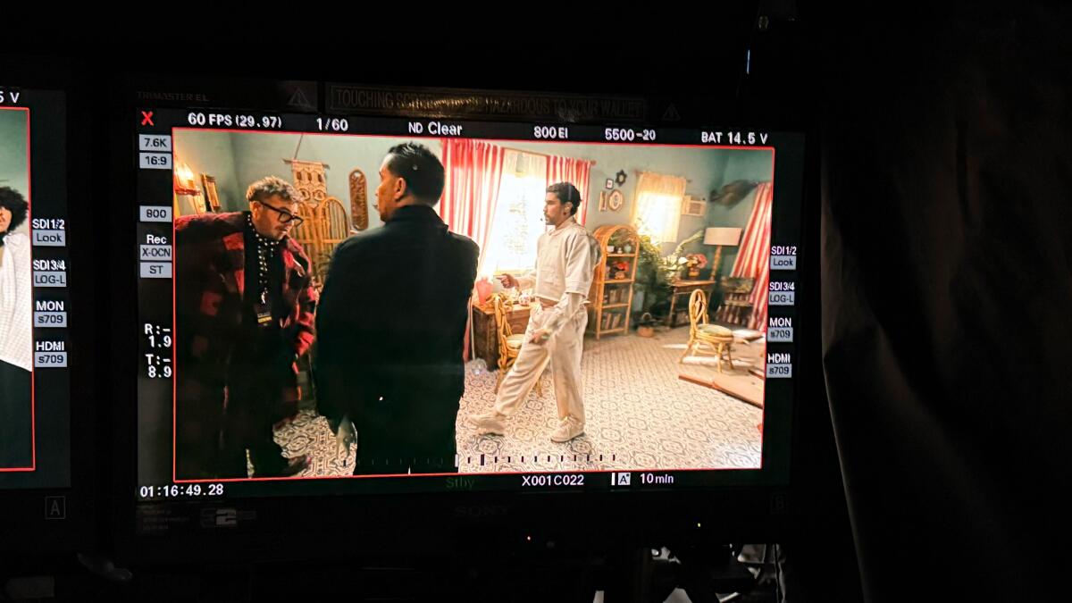 Laboureau, Fuegos LA co-owner and designer, left, on set inside the casita with Bad Bunny, right.