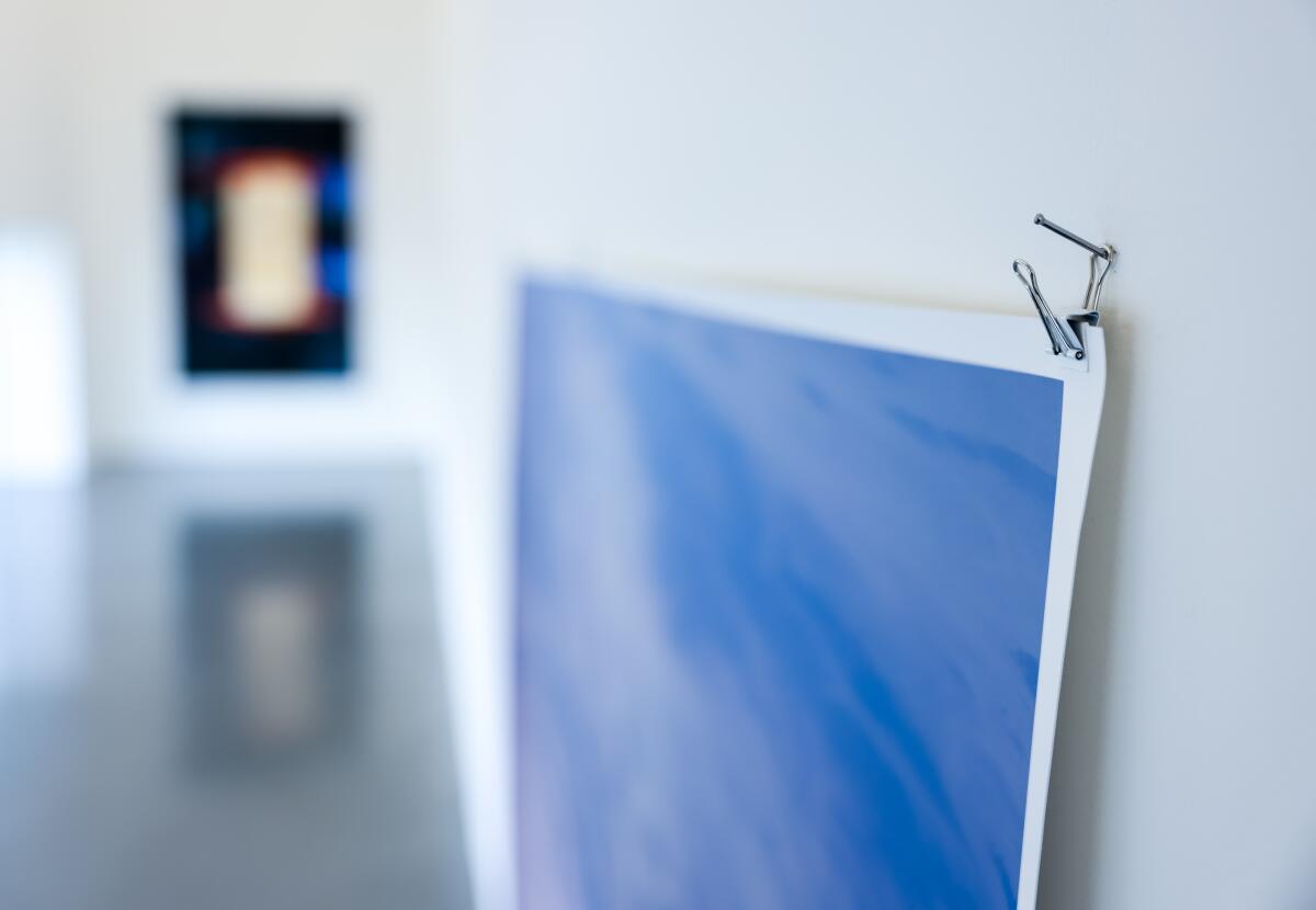 The edge of a photograph on a wall.